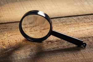 magnifying glass on the wooden background